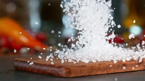 Super slow motion of falling coarse-grained salt on wooden board. Stock Footage 166964347