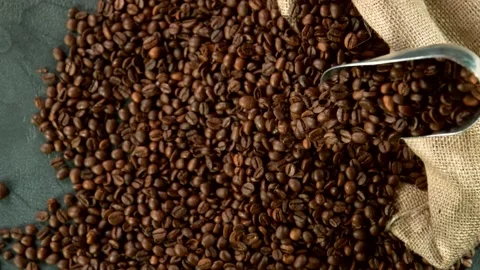Super slow motion of falling coffee beans from spoon Stock Footage 130195748