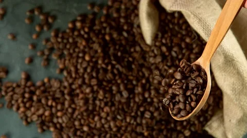 Super slow motion of falling coffee beans from spoon Stock Footage 130196461