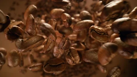 Super slow motion of falling coffee beans flying down. Stock Footage 149222360