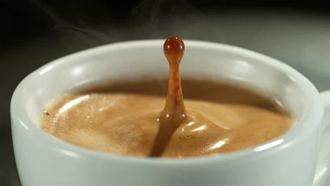 Super slow motion of falling drop into coffee with camera motion Stock Footage 235330463