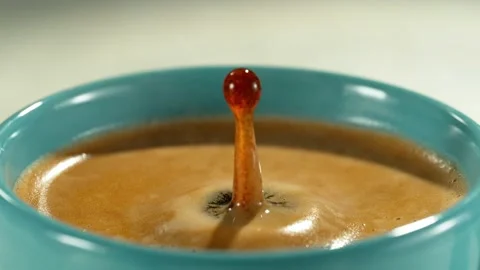Super slow motion of falling drop into coffee with camera motion Stock Footage 235330683