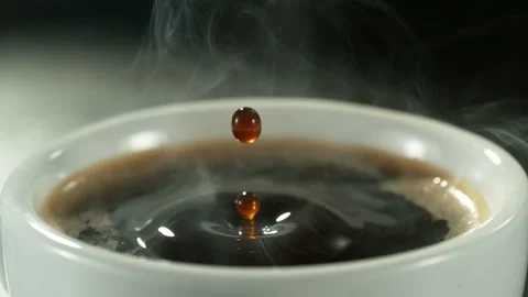 Super slow motion of falling drop into coffee with camera motion Stock Footage 235330772