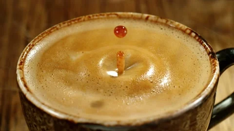Super slow motion of falling drop into coffee with camera motion Stock Footage 235330875