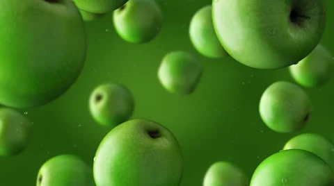 Super slow motion: falling green apples and water drops against green background Stock Footage 64846148