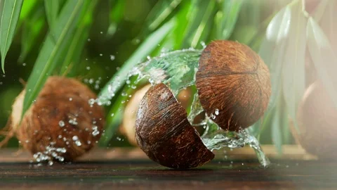 Super slow motion of falling halved coconut with splash Video stock 107047973