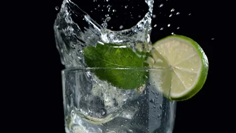 Super slow motion of falling ice cube into mojito drink, camera movement Stock Footage 146385759