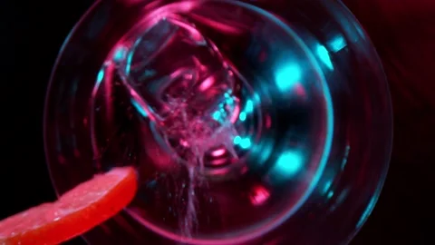 Super slow motion of falling ice cube into martini drink with camera motion Stock Footage 148692352