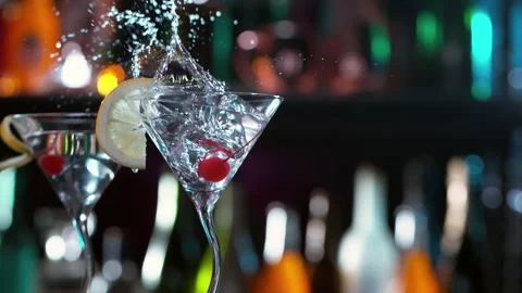 Super slow motion of falling ice cube into cocktail drink, camera movement. Stock Footage 157561166