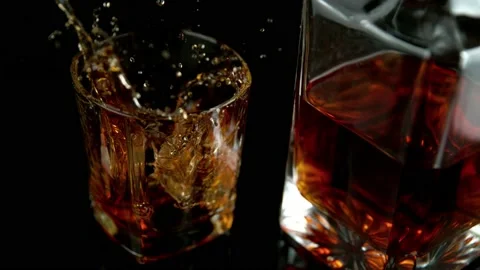 Super slow motion of falling ice cube into whiskey drink, camera motion Stock Footage 157673811
