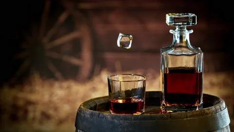 Super slow motion of falling ice cube into whiskey. Stock Footage 162786527