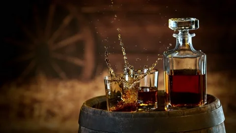 Super slow motion of falling ice cube into whiskey. Stock Footage 164547761