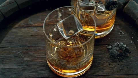 Super slow motion of falling ice cube into whisky with speed motion. Stock Footage 237167478