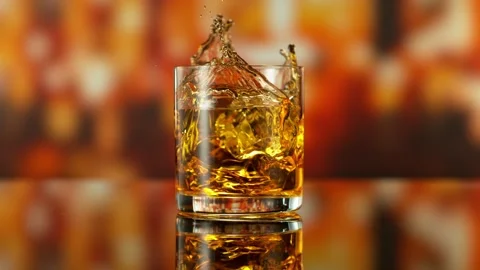 Super Slow Motion of Falling Ice into Glass of Whiskey. Stock Footage 291308944