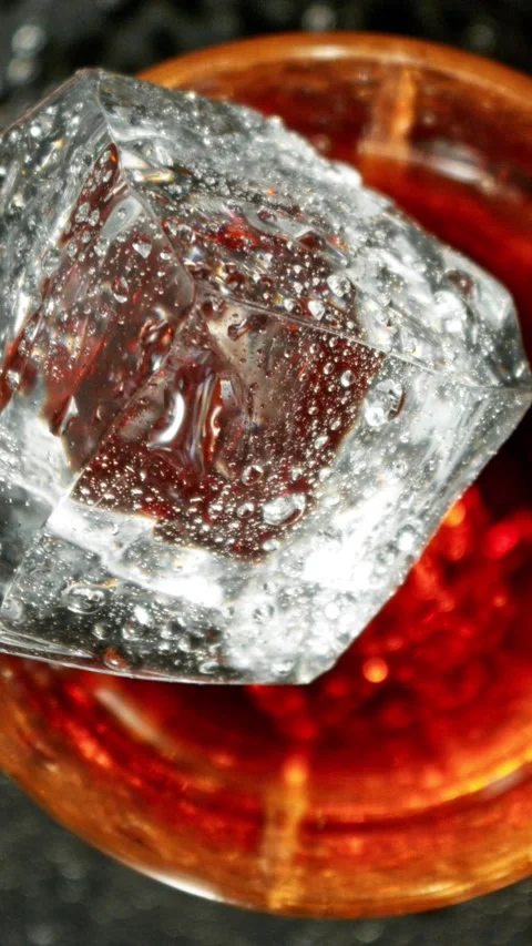 Super Slow Motion of Falling Ice Cube into Cola Drink. Stock Footage 293088401