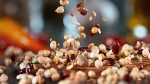 Super slow motion of falling  legumes mix on wooden board. Stock Footage 166965248