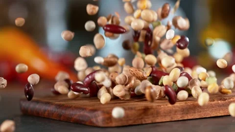 Super slow motion of falling  legumes mix on wooden board. Stock Footage 166968919
