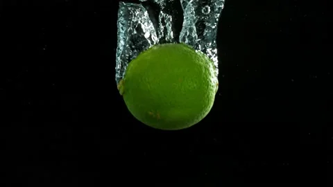 Super slow motion of falling lime into splashing water Stock Footage 212008746