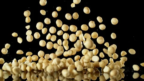 Super Slow Motion of Falling Macadam Nuts with Reflection Stock Footage 251794635