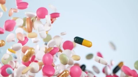 Super slow motion of falling mixed pills on white background 124000837