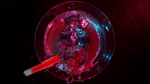 Super slow motion of falling olives into martini drink Stock Footage 148691687