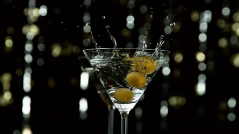 Super slow motion of falling olives into cocktail drink, camera movement Stock Footage 166115457