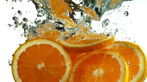Super slow motion of falling orange slices with speed ramping Stock Footage 118977434