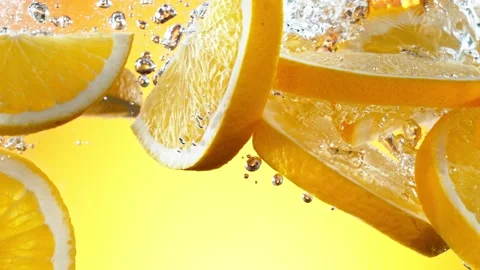 Super slow motion of falling orange slices into water. Stock Footage 207462875