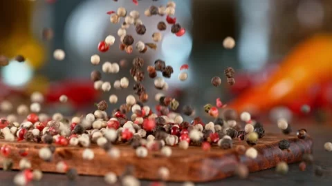Super slow motion of falling pepper spice on wooden board. Stock Footage 166964321