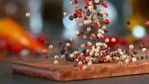 Super slow motion of falling pepper spice on wooden board. Stock Footage 166964764