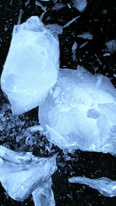 Super slow motion of falling piece of ice on black background. Stock Footage 296741469