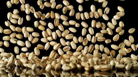 Super Slow Motion of Falling Pistachio Nuts with Reflection Stock Footage 251795854