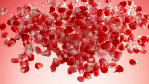 Super slow motion of falling pomegranate pieces into water. Stock Footage 212053407