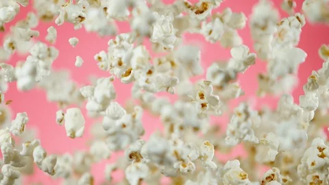 Super slow motion of falling popcorn on pink background Stock Footage 114971675