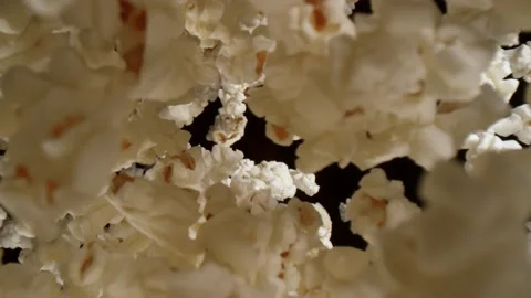 Super slow motion of falling popcorn, wide macro shot. Stock Footage 165662229