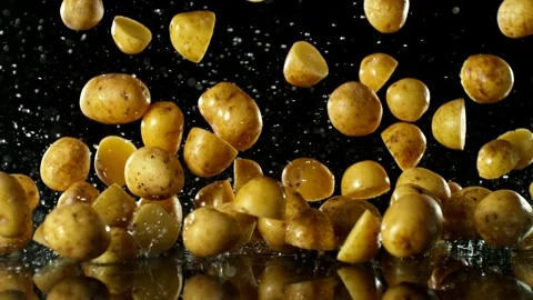 Super Slow Motion of Falling Potatoes on Black Background. Stock Footage 251806437