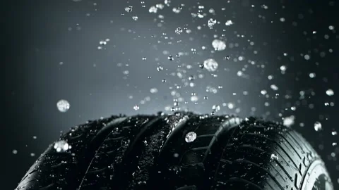 Super slow motion of falling rain on rotating tire sample, close-up. Stock Footage 162606744