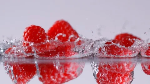 Super slow motion of falling raspberries into water, 1000 fps Stock Footage 90667454