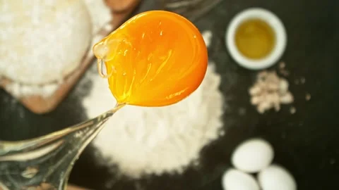Super Slow Motion of Falling Raw Egg into Flour. Stock Footage 304518202