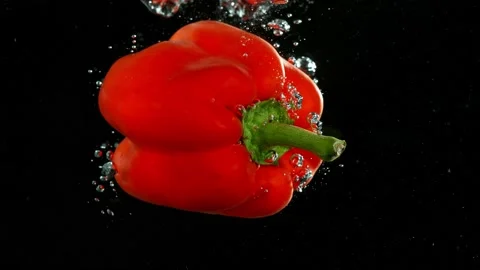Super slow motion of falling red pepper underwater. Stock Footage 212011297