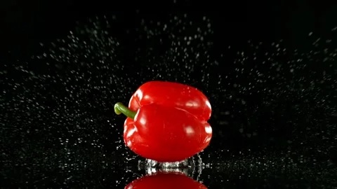 Super Slow Motion of Falling Red Pepper into Water on Black Background. Stock Footage 251661566