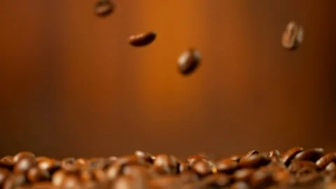 Super slow motion of falling roasted coffee beans. Stock Footage 94686136
