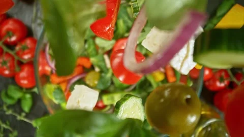 Super Slow Motion of Falling Salad Pieces into Bowl. Stock Footage 275579013