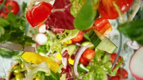 Super Slow Motion of Falling Salad Pieces into Bowl. Stock Footage 304504525