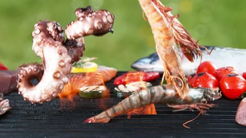 Super slow motion of falling shrimps and octopus tentacle on grill grid. Stock Footage 154077960