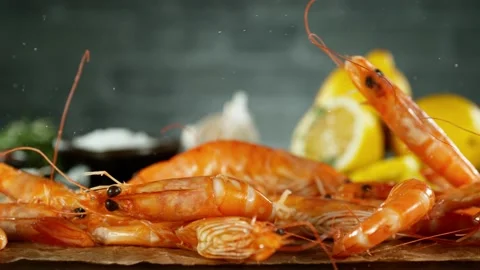 Super slow motion of falling shrimps on black background. Stock Footage 238463848