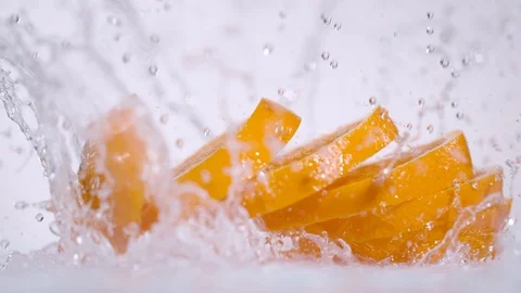 Super slow motion of falling sliced orange into water, 1000 fps Stock Footage 90666875