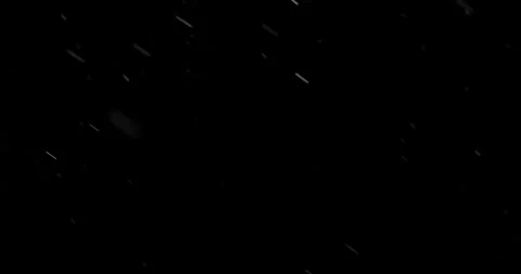Super slow motion falling snow or dust particles isolated on a black background. Vidéo 335086764