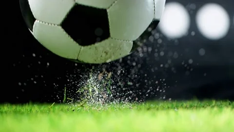 Super slow motion of falling soccer ball on lawn. Stock Footage 156321725