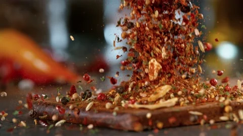 Super slow motion of falling spice mix on wooden board. Stock Footage 166970335